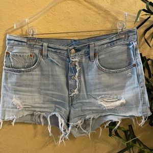 Denim 501 Levi’s button fly distressed shorts.